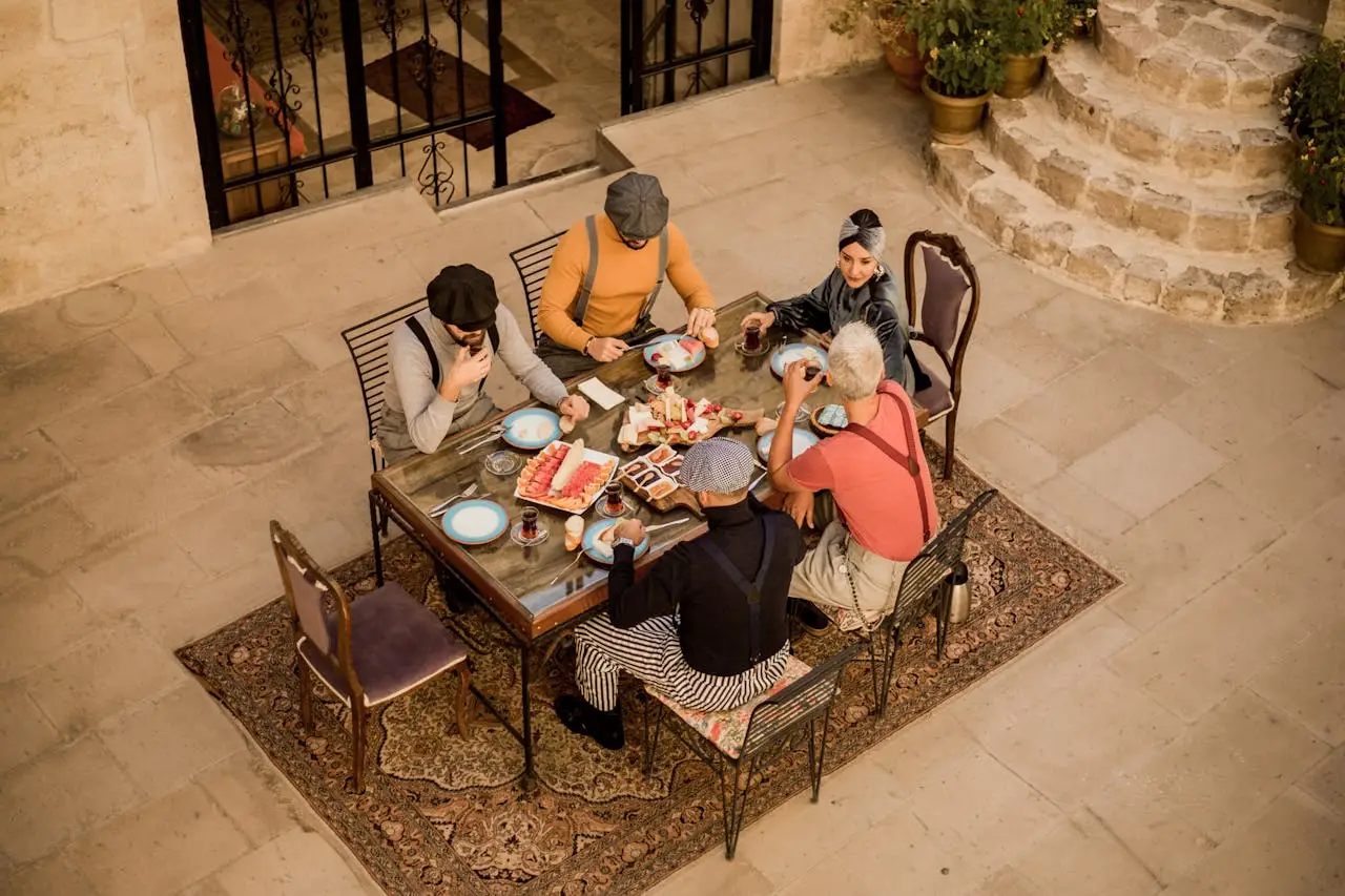 A group enjoying a traditional Turkish breakfast outdoors in Ürgüp, Türkiye.